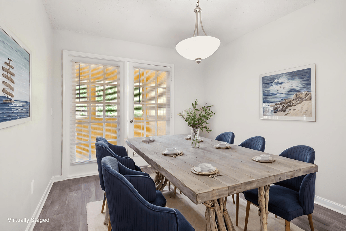 Virtually staged dining space open to the kitchen in a Quail Run apartment home